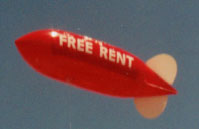 helium advertising blimp balloon with Free Rent lettering